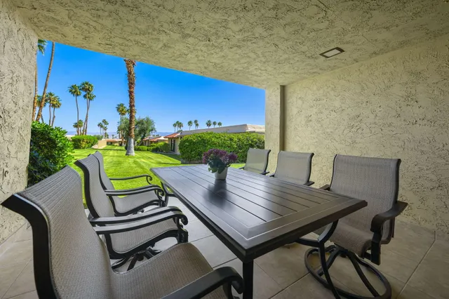 a view of a chairs and table in patio