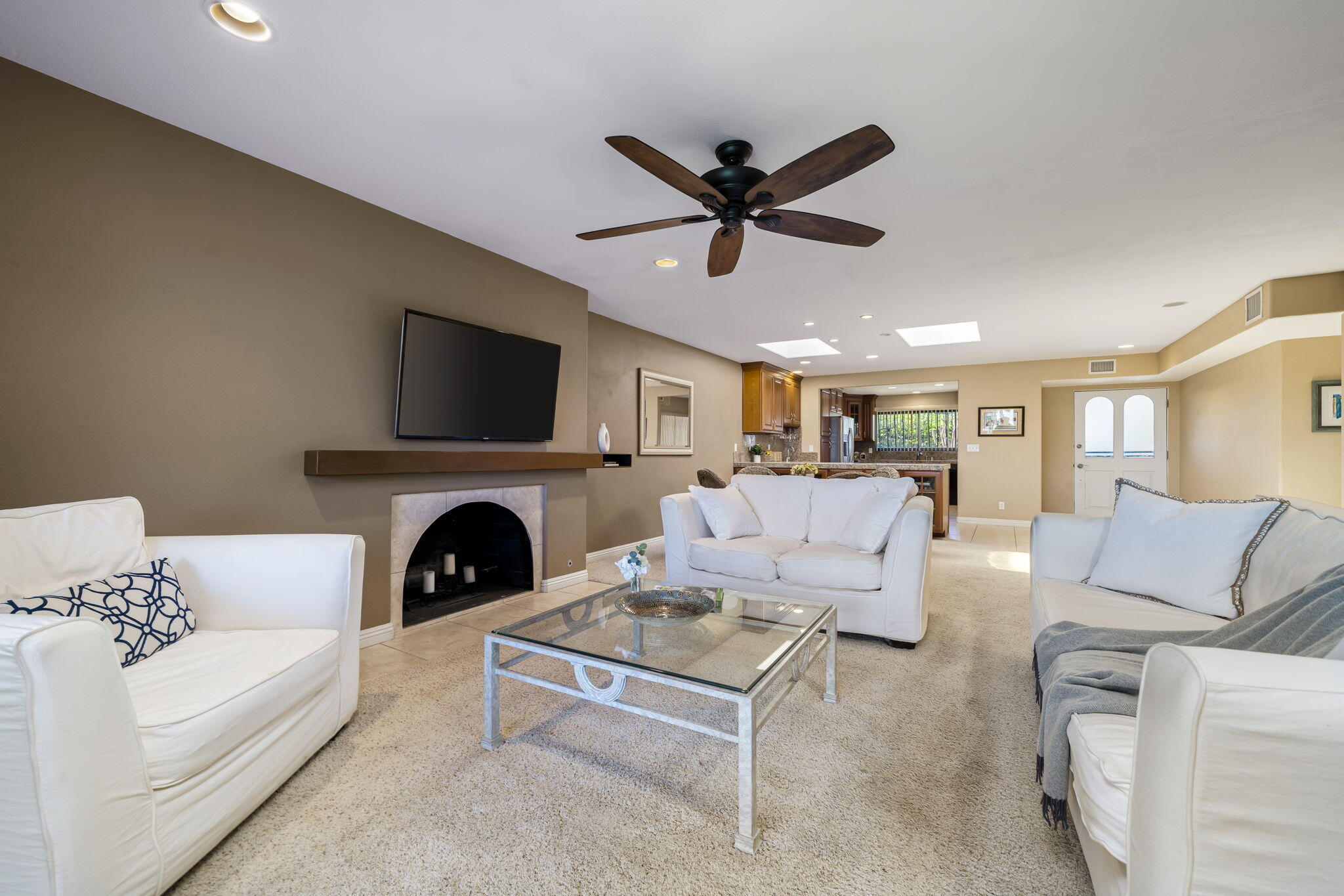 72930 Mesa View Drive Palm Desert, CA 92260 - Photo 5 of 40 a living room with furniture a fireplace and a flat screen tv