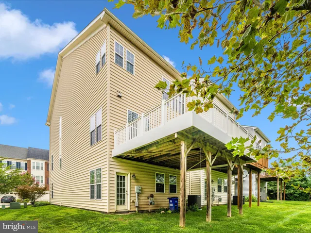 a view of a livingroom with wooden floor and furniture