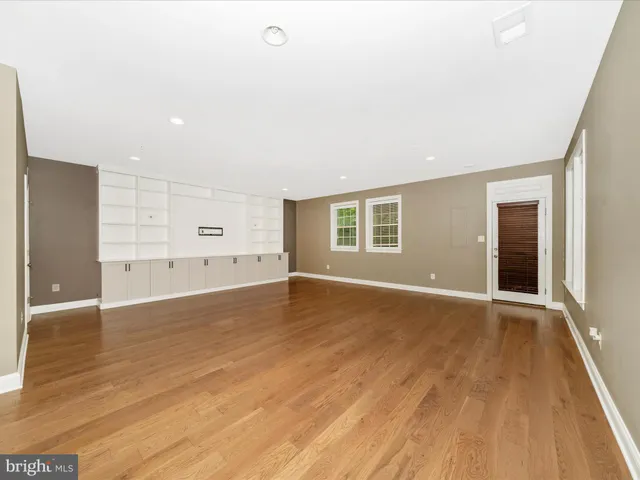 a kitchen with stainless steel appliances kitchen island granite countertop a refrigerator and a stove top oven