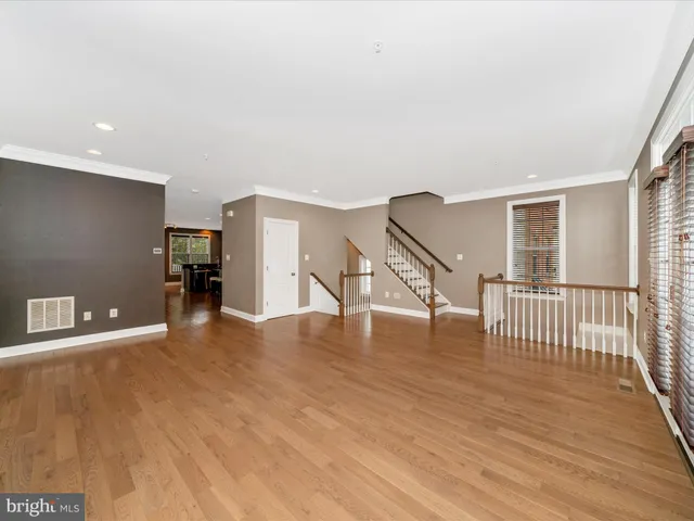 a view of a kitchen with kitchen island a large window cabinets and stainless steel appliances