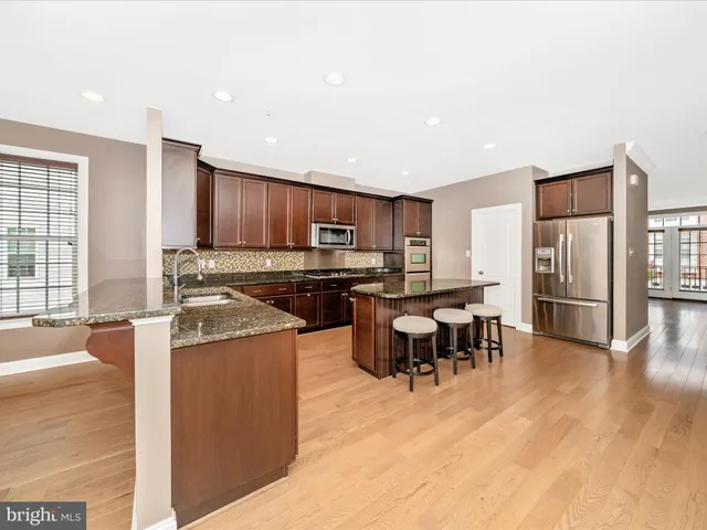 a view of a kitchen with a sink and a refrigerator