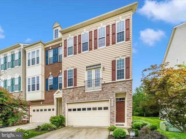 a view of a brick house with a yard and plants