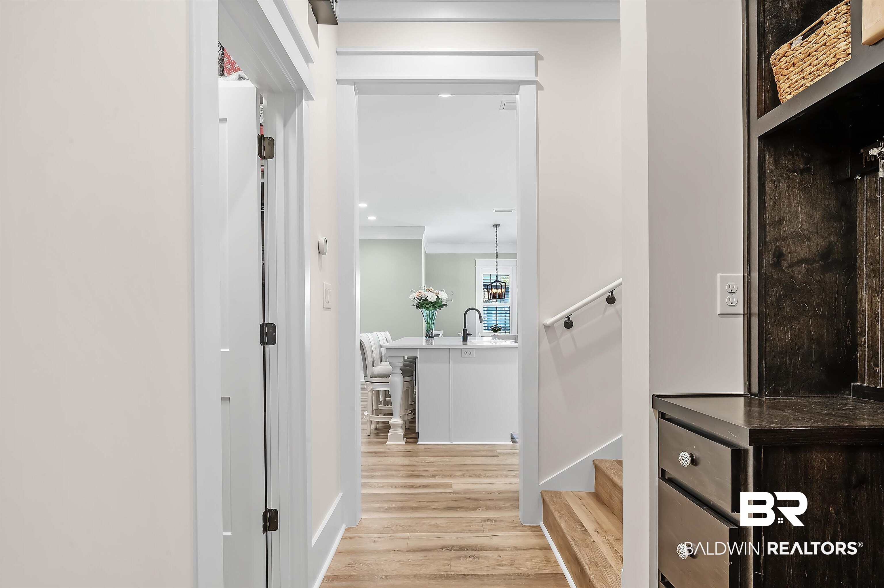 9144 Harvest Ridge Fairhope, AL 36532 - Photo 41 of 58 Corridor featuring a sink, crown molding, and light wood-style floors