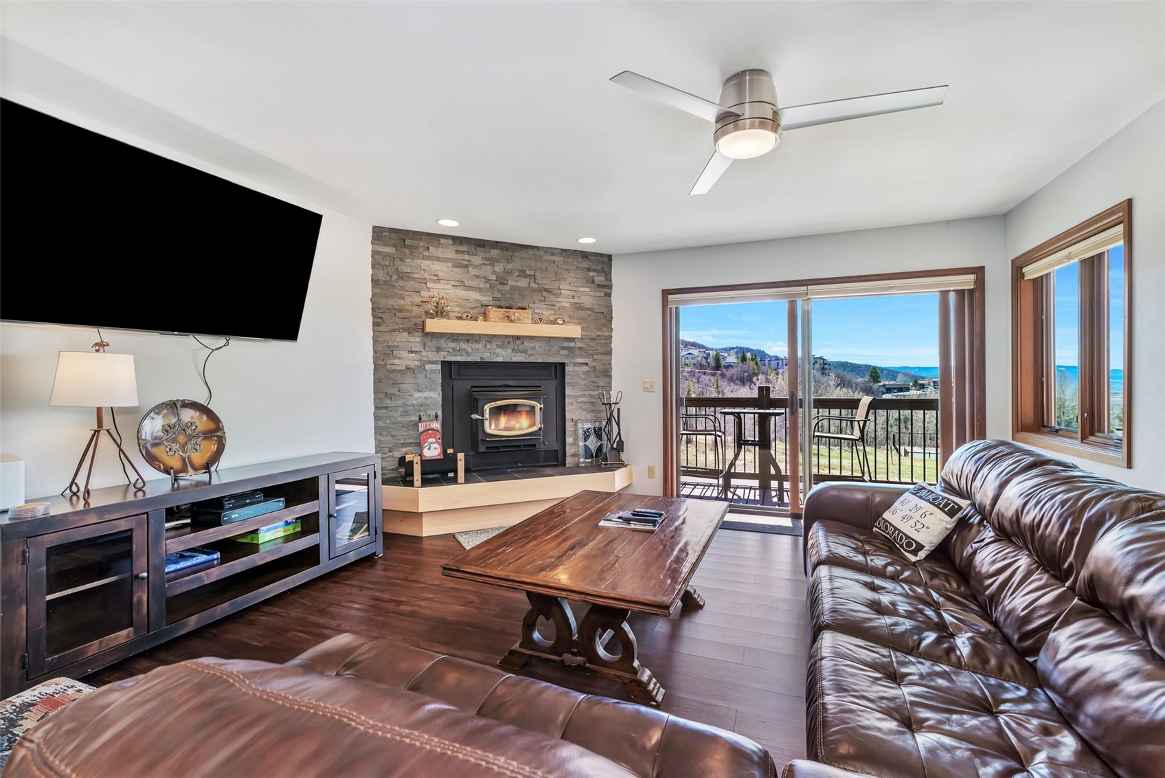 1720 Ranch Road, Unit 309 Steamboat Springs, CO 80487 - Photo 5 of 43 a living room with furniture a flat screen tv and a fireplace