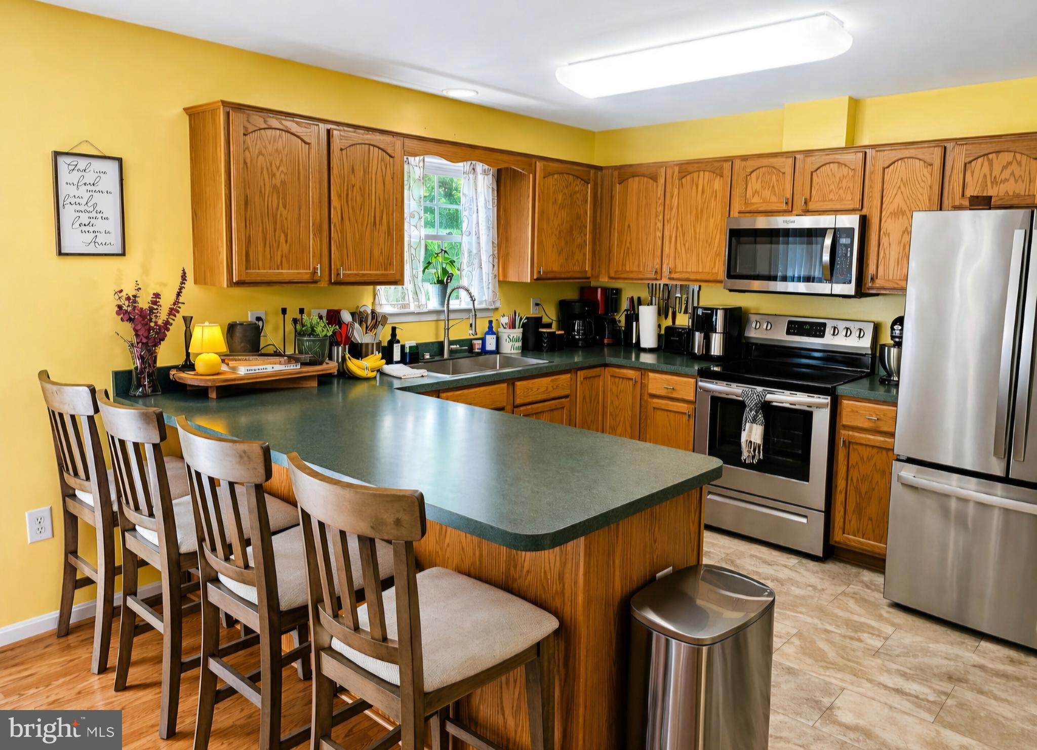 61 Clemson Lane Falling Waters, WV 25419 - Photo 12 of 37 a kitchen with a table chairs sink and refrigerator
