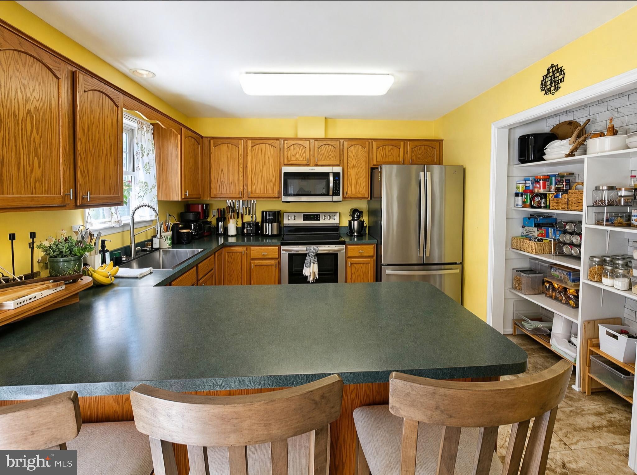 61 Clemson Lane Falling Waters, WV 25419 - Photo 13 of 37 a kitchen with a table chairs and a refrigerator