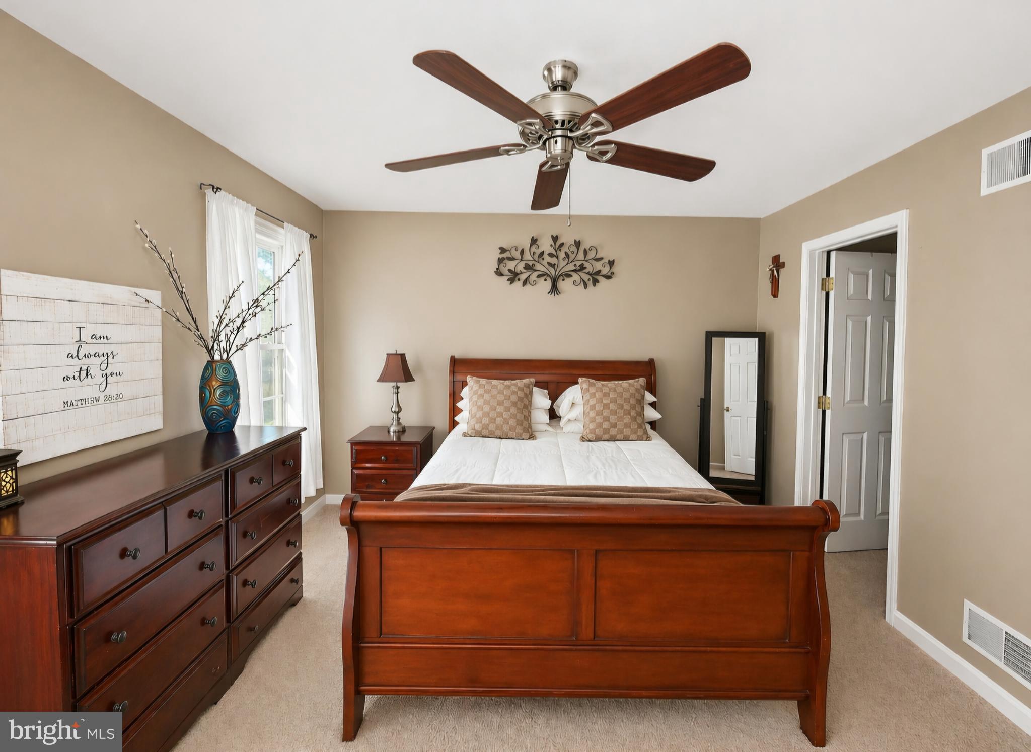 61 Clemson Lane Falling Waters, WV 25419 - Photo 16 of 37 a bedroom with a bed and a chandelier