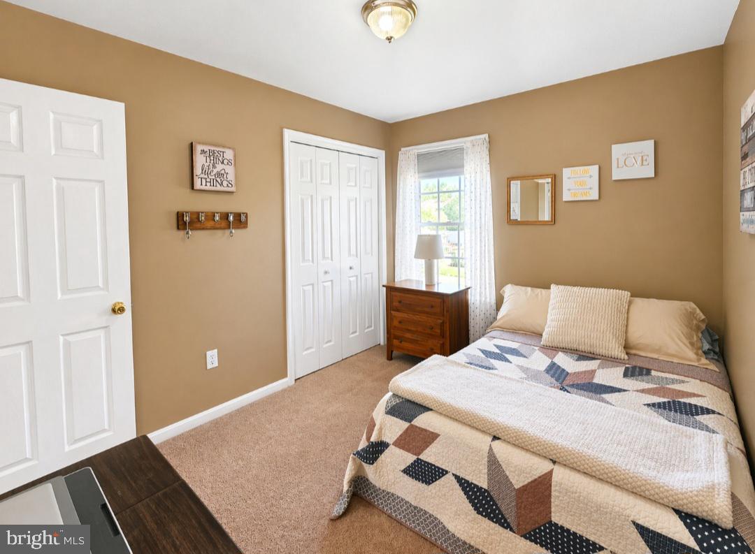 61 Clemson Lane Falling Waters, WV 25419 - Photo 21 of 37 a bedroom with a bed and wooden floor