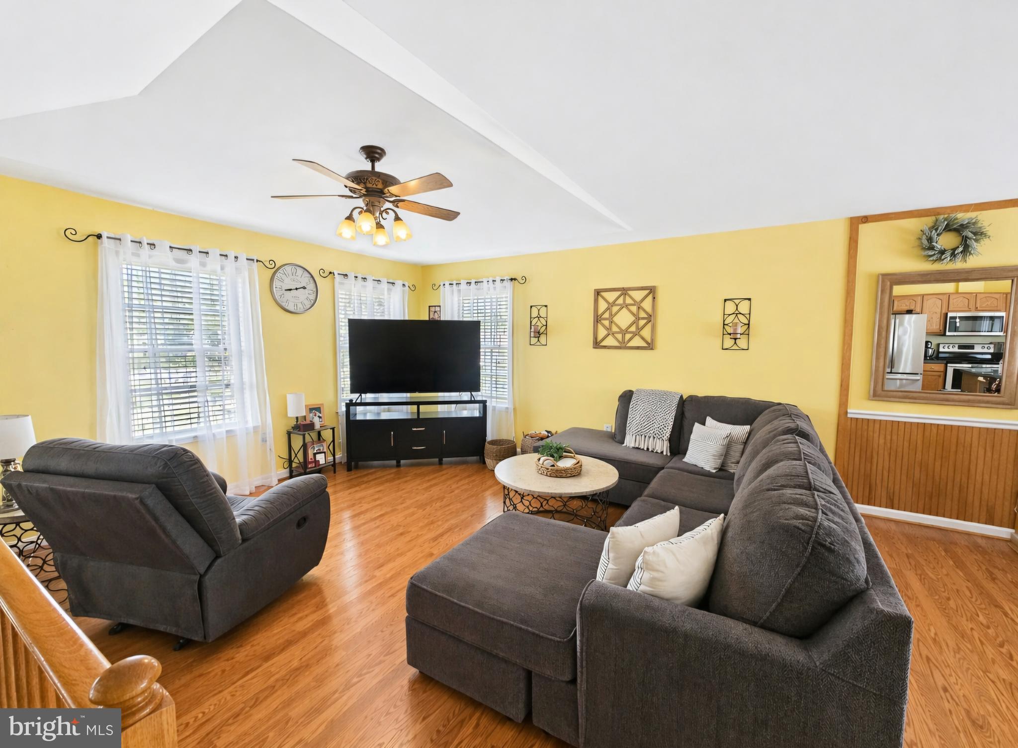 61 Clemson Lane Falling Waters, WV 25419 - Photo 7 of 37 a living room with furniture ceiling fan and a flat screen tv