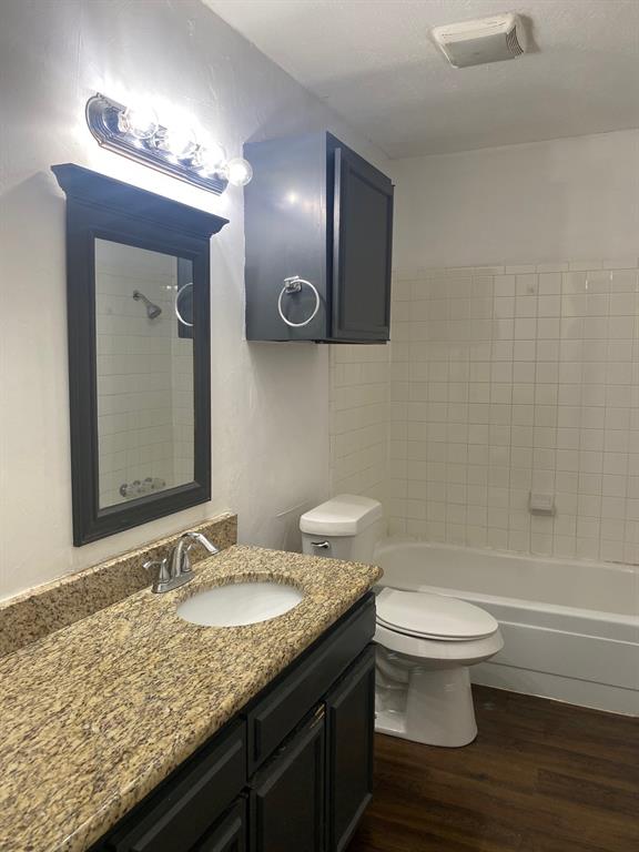 13652 Flagstone Lane Dallas, TX 75240 - Photo 9 of 15 Bathroom with vanity, dark wood-style flooring, and shower / bath combination