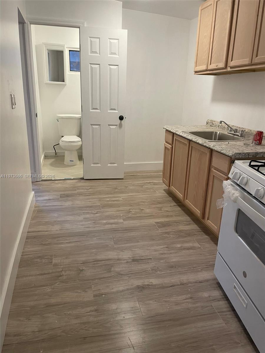 746 Northeast 80th Street, Unit E2 Miami, FL 33138 - Photo 2 of 9 a view of a kitchen with wooden floor