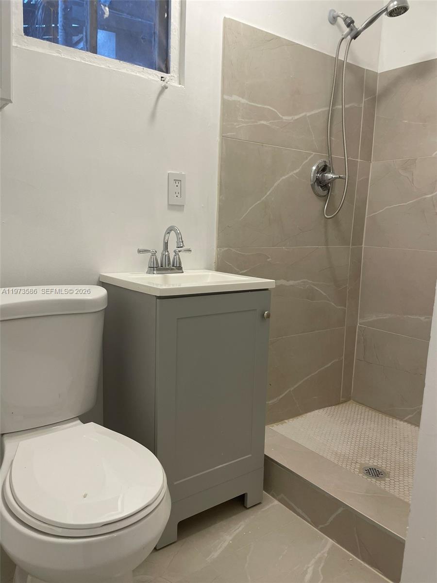 746 Northeast 80th Street, Unit E2 Miami, FL 33138 - Photo 9 of 9 a bathroom with a sink a toilet and shower