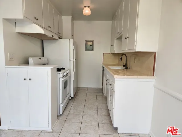 a kitchen with a sink a stove and refrigerator