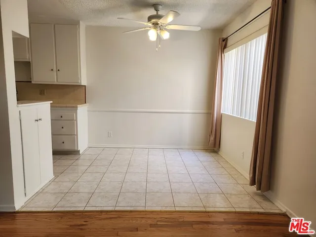 a view of a kitchen with dishwasher and a refrigerator