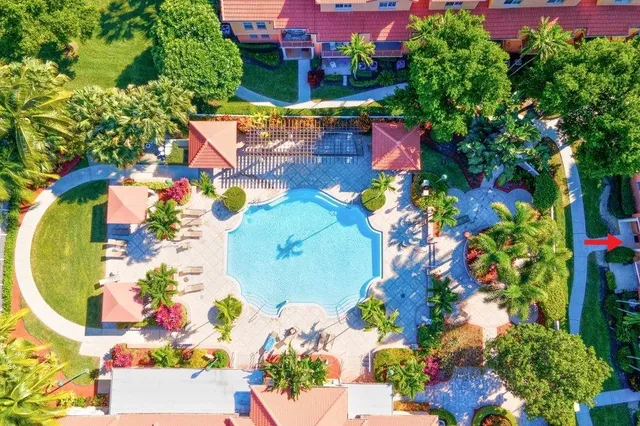 a view of a house with a small yard and wooden fence