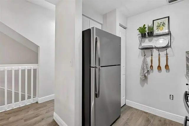 a metallic refrigerator freezer sitting in a kitchen