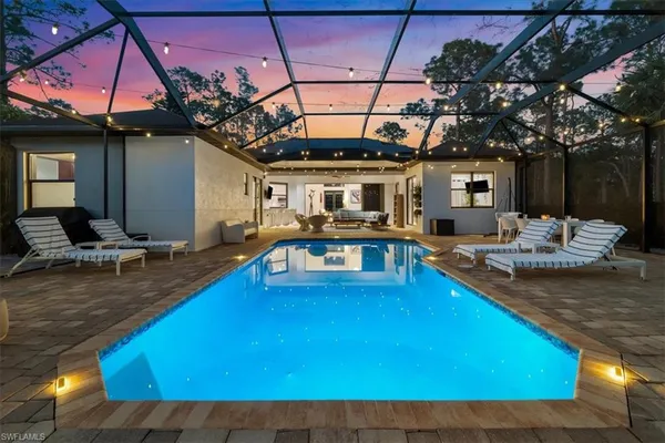 a swimming pool with outdoor seating yard and furniture