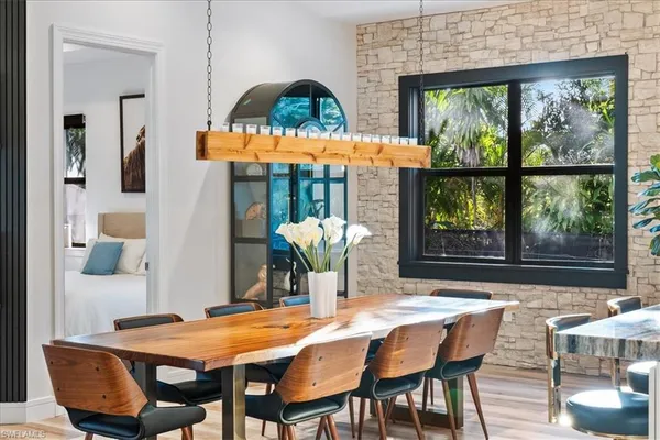 a dining room with furniture a rug and a large window