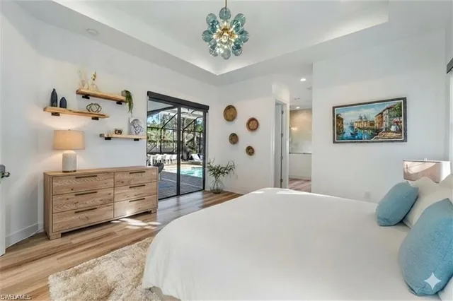 a bedroom with a bed and a chandelier