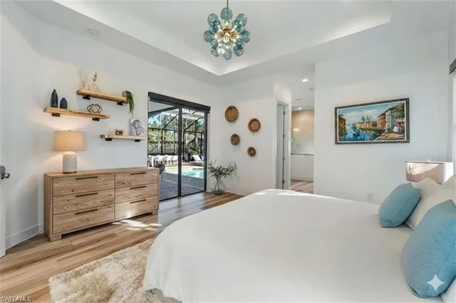 a bedroom with a bed and a chandelier