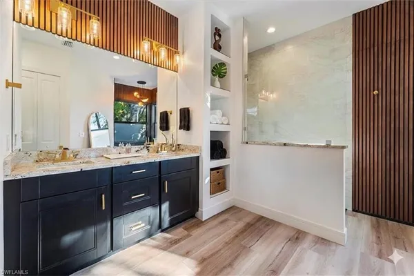 a bathroom with a sink a mirror and a shower