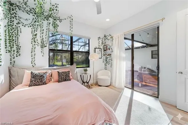 a bedroom with a large bed and a chandelier
