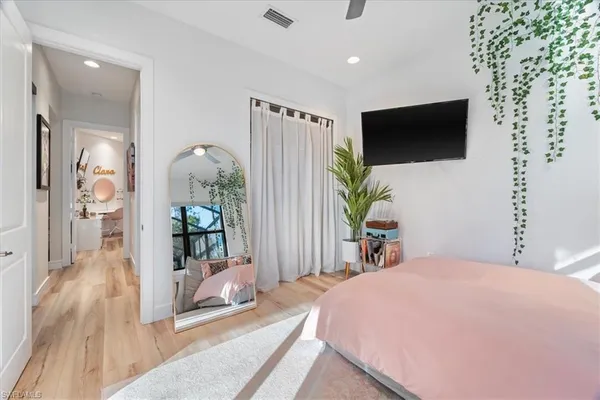 a bedroom with a bed and a flat screen tv