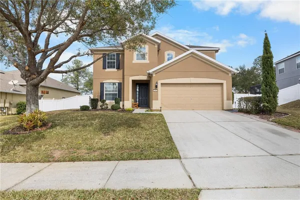 a front view of a house with a yard and garage