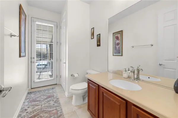 a bathroom with a sink a toilet and mirror