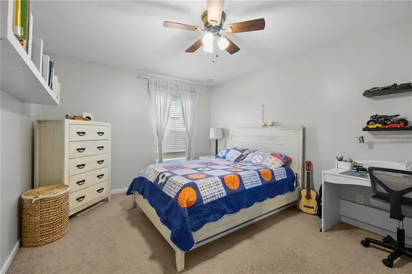 a bed room with bed and a book shelf