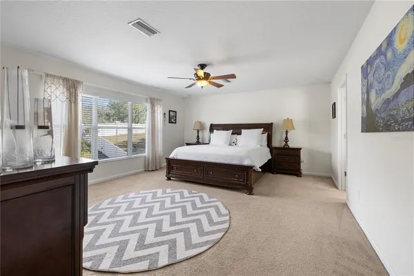 a bathroom with double vanity sinks a vanity a lamp and a mirror