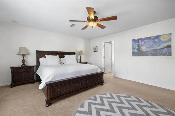 a bathroom with a granite countertop tub double vanity sink and a large mirror
