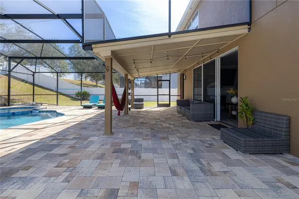 a view of a house with backyard and sitting area