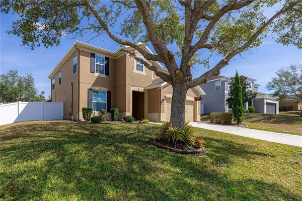 an aerial view of a house with a yard basket ball court and outdoor seating