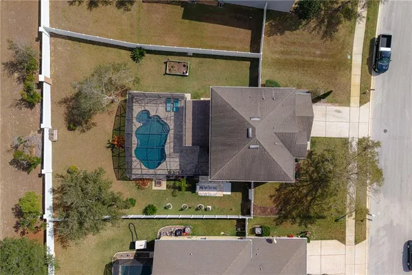 an aerial view of residential houses with outdoor space and lake view