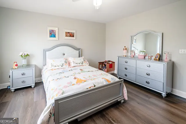 a bedroom with a bed and a dresser