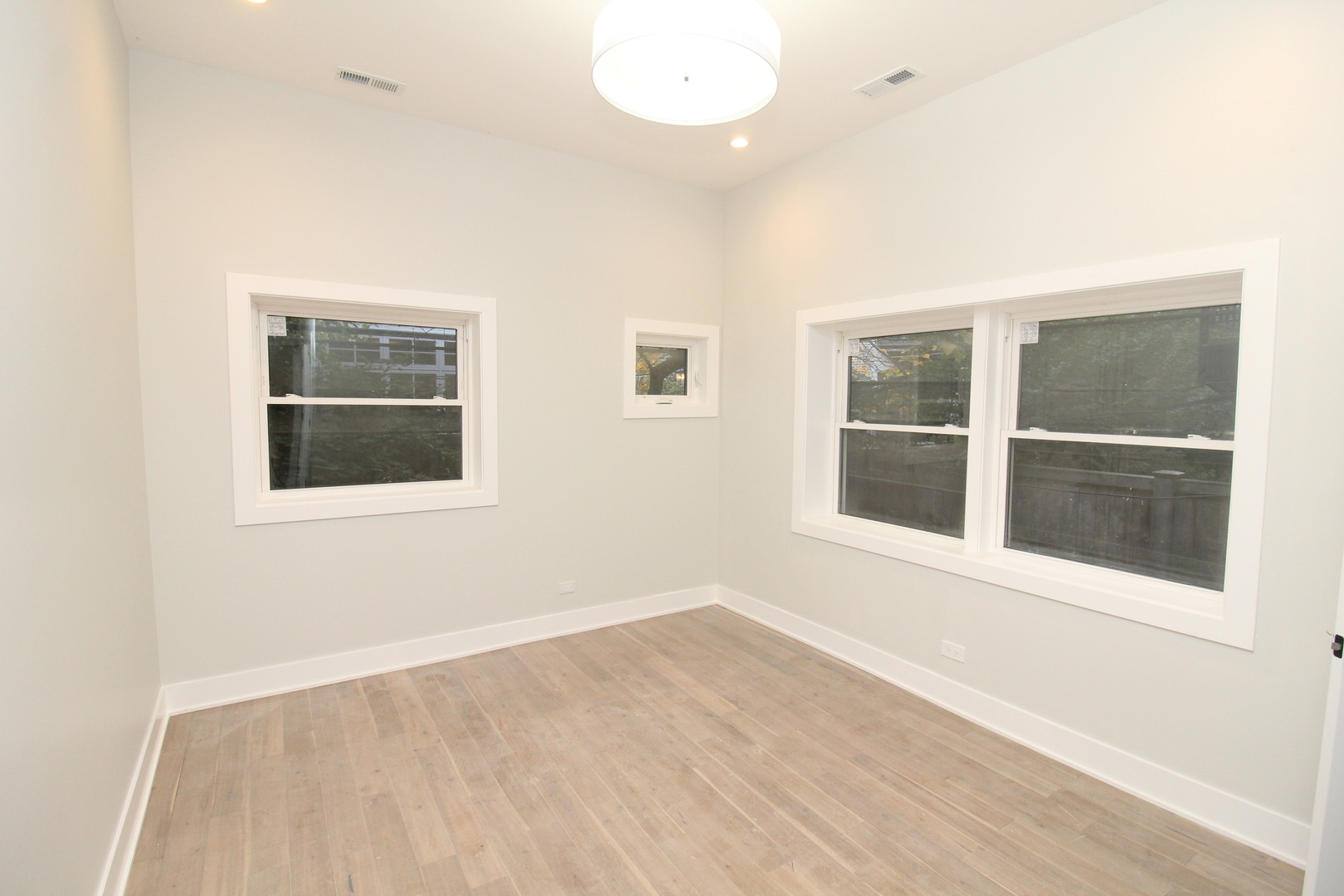 64 East Cedar Street, Unit 2R Chicago, IL 60611 - Photo 12 of 17 an empty room with wooden floor and windows