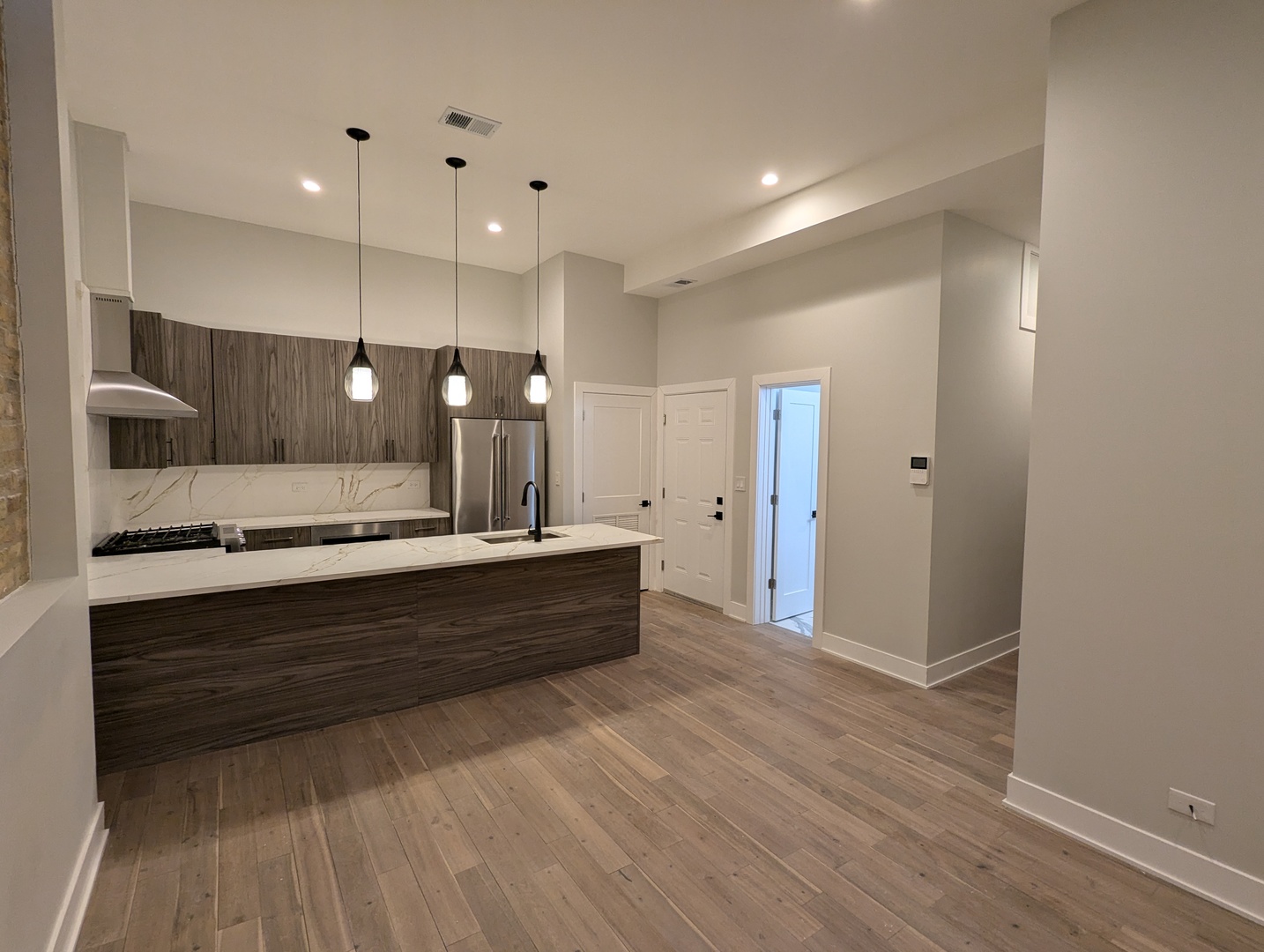 64 East Cedar Street, Unit 2R Chicago, IL 60611 - Photo 2 of 17 a bathroom with a sink a large mirror and shower