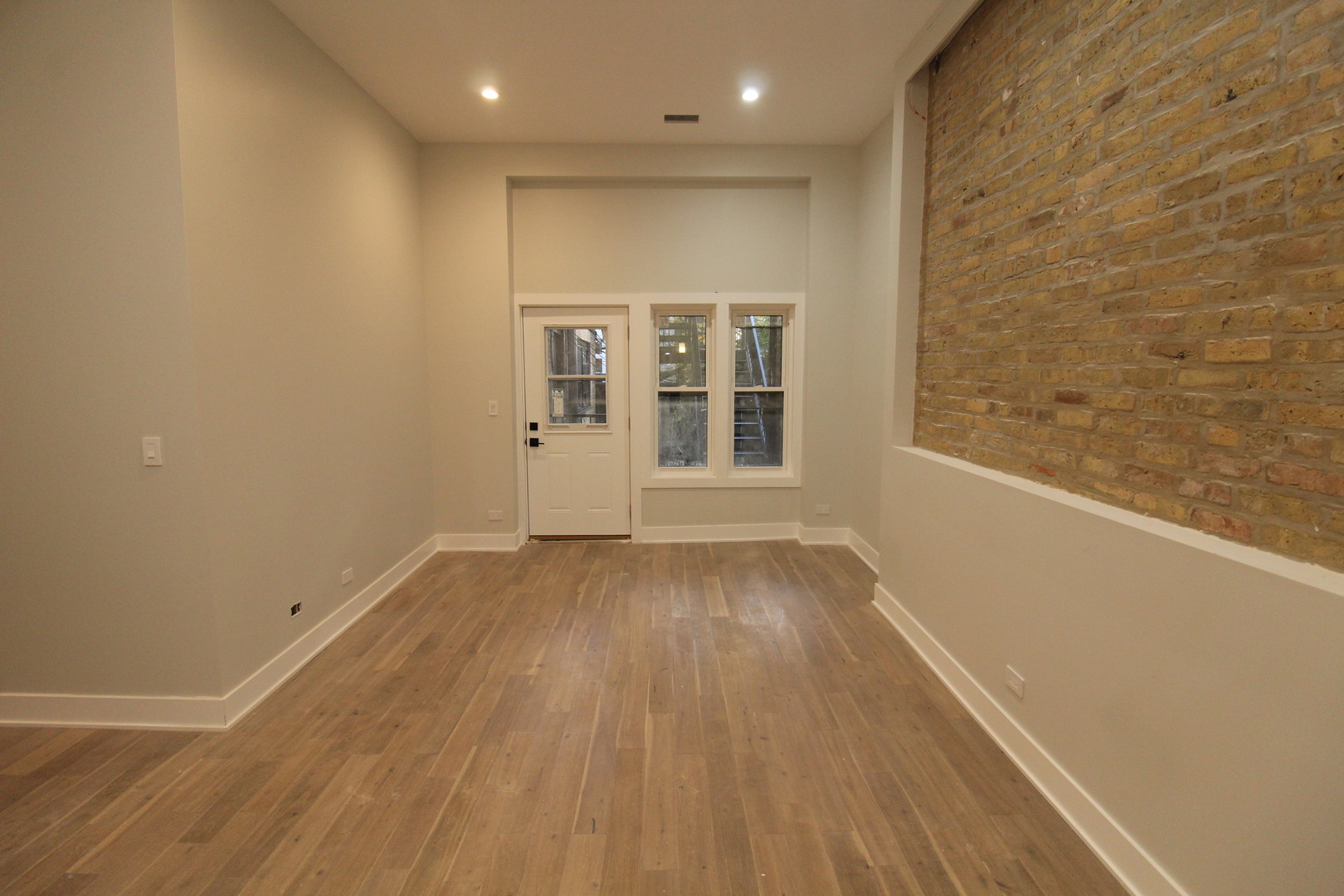 64 East Cedar Street, Unit 2R Chicago, IL 60611 - Photo 6 of 17 an empty room with wooden floor and windows