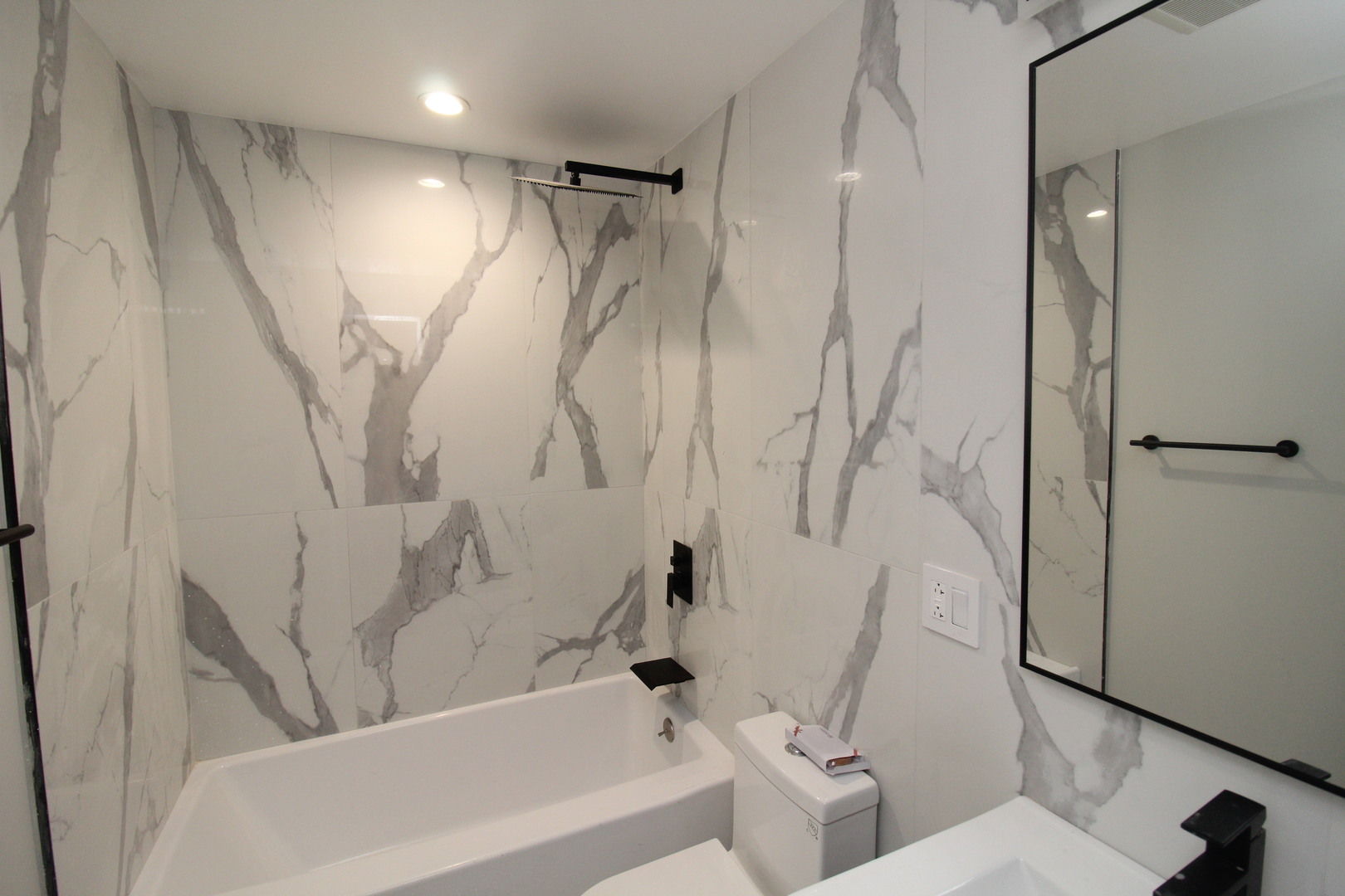 64 East Cedar Street, Unit 2R Chicago, IL 60611 - Photo 7 of 17 a bathroom with a shower and a toilet