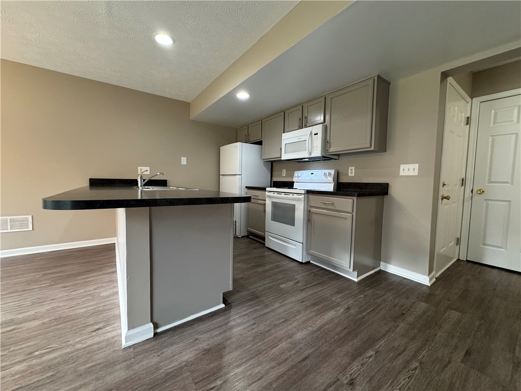 778 Royal Sunset Drive Webster, NY 14580 - Photo 16 of 38 View of typical kitchen with large breakfast bar