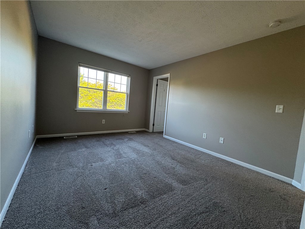 778 Royal Sunset Drive Webster, NY 14580 - Photo 22 of 38 Typical primary bedroom with carpeting and large w
