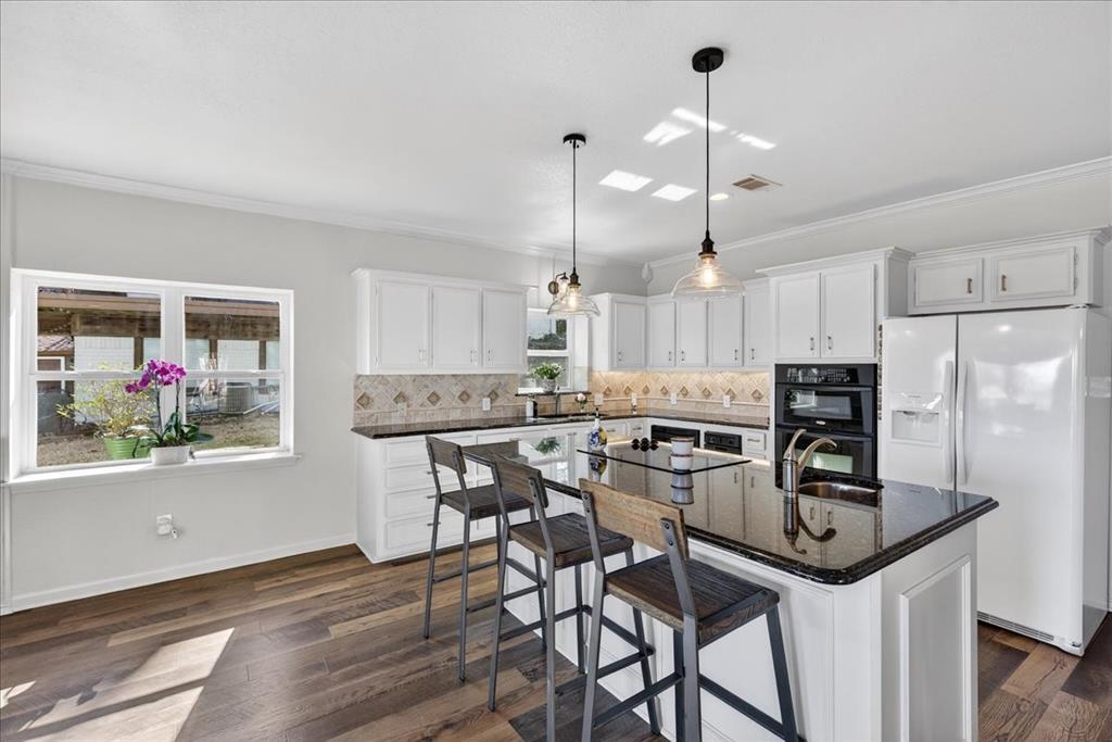353 Winding Shore Tool, TX 75143 - Photo 12 of 35 a kitchen with kitchen island a dining table chairs stainless steel appliances and cabinets