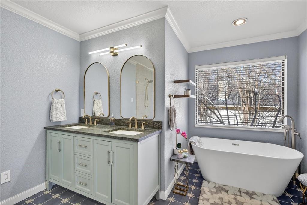 353 Winding Shore Tool, TX 75143 - Photo 21 of 35 a bathroom with a double vanity sink a two mirror a bathtub and next to a window