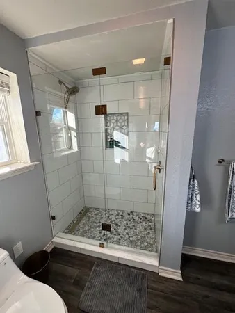 a bathroom with a bathtub and shower