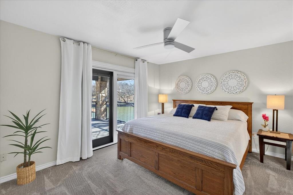 353 Winding Shore Tool, TX 75143 - Photo 25 of 35 a bedroom with a large bed and a chandelier