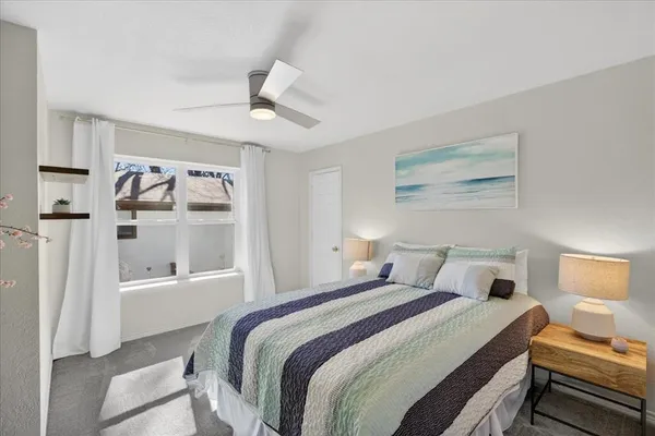 a bedroom with a bed and a window