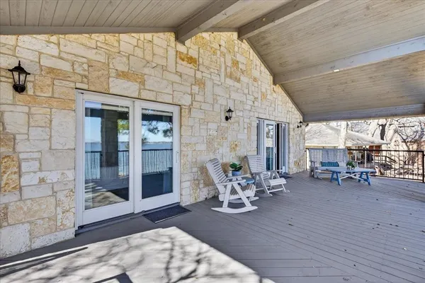 a view of a patio with table and chairs and wooden floor