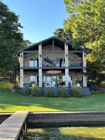 a view of a house with a swimming pool and a yard